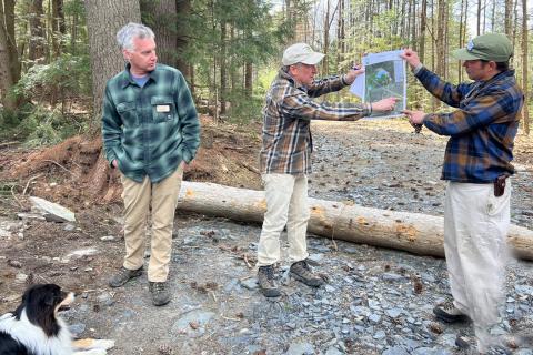 Dode Gladders, Lionel Chute, Jeremy Turner viewing land map on log landing before forest tour