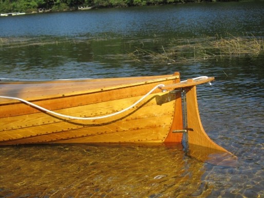 Orange colored stern knee onsailing canoe.