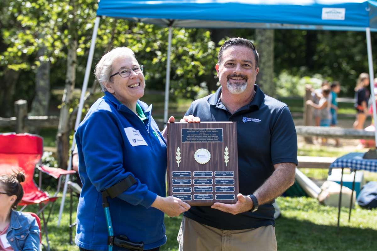 Mary Davis receives the Program of Distinction Award from Ken La Valley