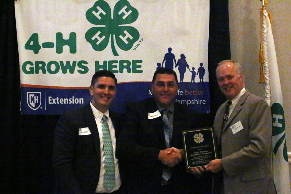 A representative of Major Waldron's Sportsmen Association receives the Friend of 4-H Business award