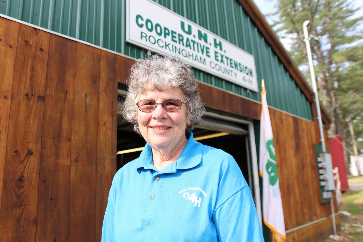 Former Rockingham County 4-H Extension Educator Lynn Garland poses in front of the Rockingham County 4-H Exhibit Hall at the Deerfield Fair grounds