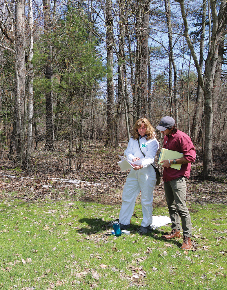 Rachel talks with camp director in a field