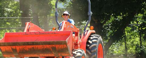 A women farmer on a tractor