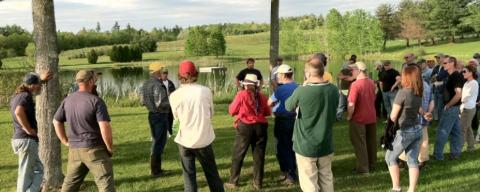 Field specialist presenting to a group of farmers