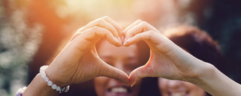 people making heart with hands