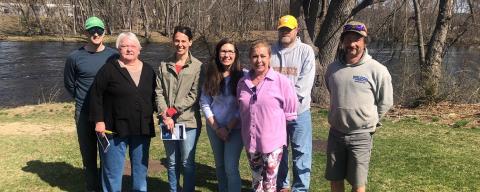 Group of volunteers standing near the Contoocook River