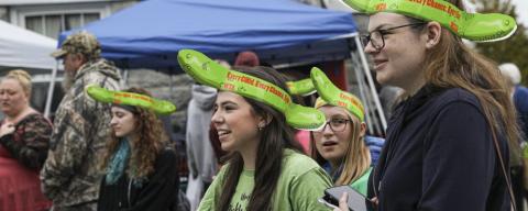 festival attendees wearing pickle hats