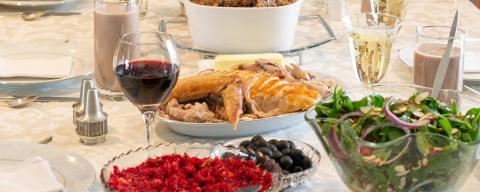 Dinner table set with food and drinks for Thanksgiving