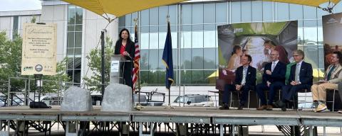 New Hampshire Governor Kelly Ayotte at a podium on a stage