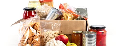 a box with bags, jars, and cans of food