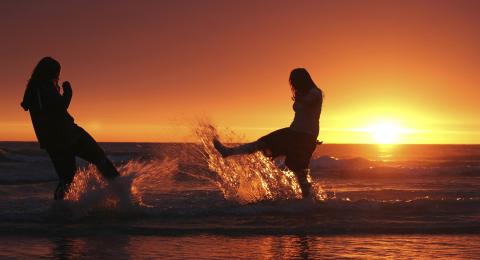 two people enjoying a beach sunrise