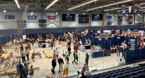 Indoor areana at St. Anselm College with contruction trades booths and people milling around