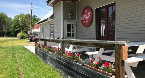 Exterior deck with picnic tables of a trailside business in Ossipee New Hampshire