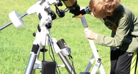 Boy looklng into telescope
