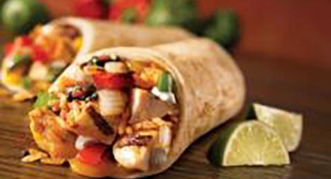 Chicken fajitas with a wedges of lime on the side.