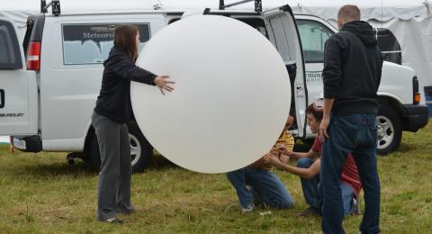 People launching weather balloon