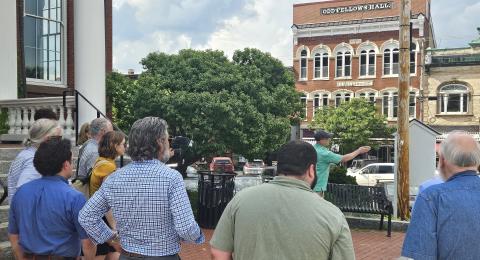 Darren Winham pointing towards downtown Exeter in front of the group