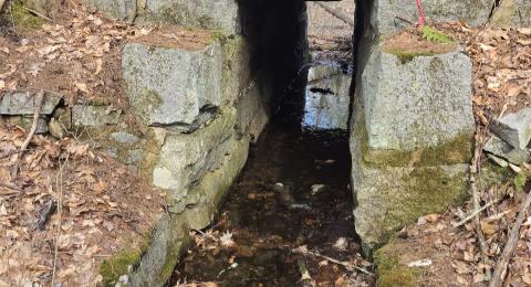 Old stone railroad bridge over a stream in Barrington near the new library.