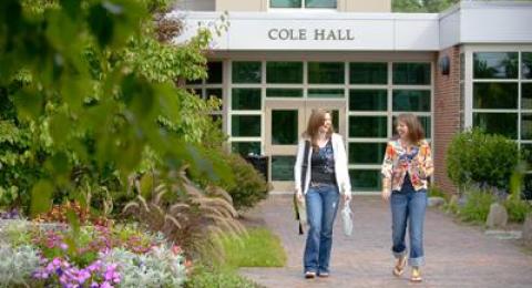 Two people walking away from a building