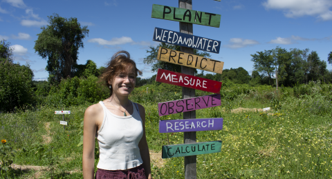 woman in garden next to sign