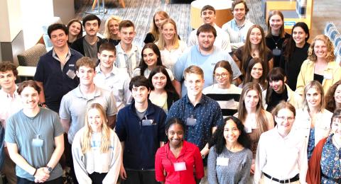many students in a group posing for picture