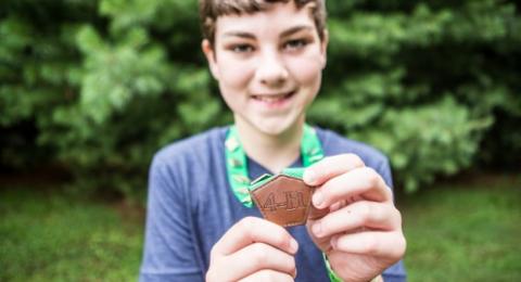 4-Her holding project medals