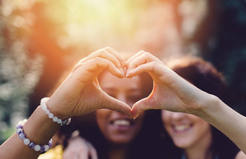 people making heart with hands