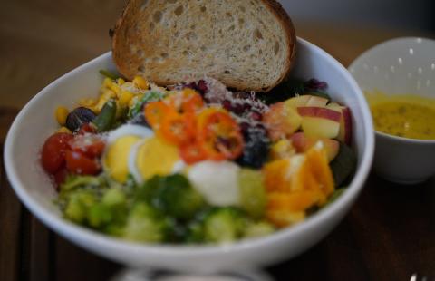 Salad with vegetables and fruit with a slice of bread