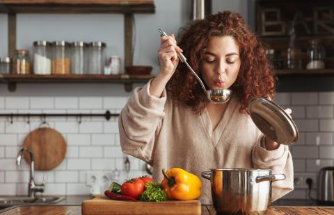  Photo of pretty caucasian woman holding cooking ladle spoon while eating soup at home By Drobot Dean/adobe.stock.com