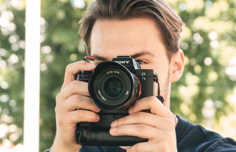 Man holding camera in front of face