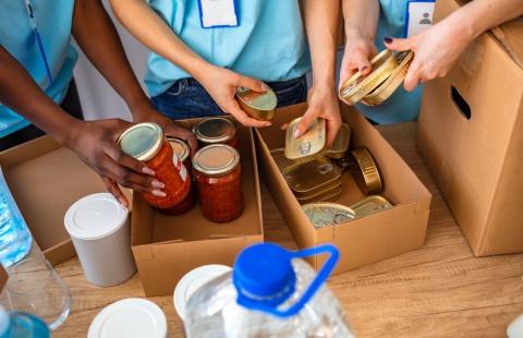 people packing boxes of donated food