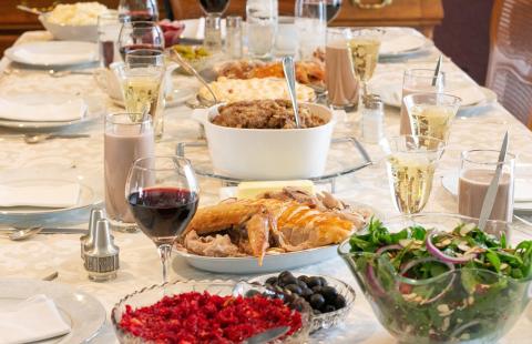 Dinner table set with food and drinks for Thanksgiving