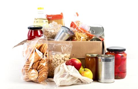 a box with bags, jars, and cans of food