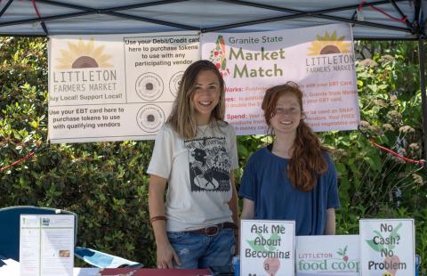 Volunteers pose at the Granite State Market Match booth at the Littleton Farmers Market