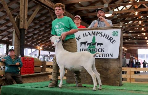boy at auction with goat