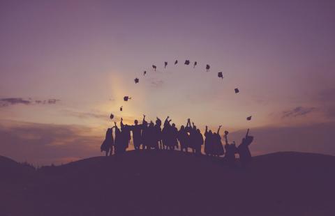 Graduates throwing caps in the air