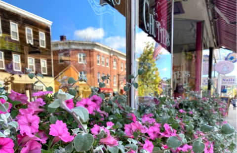 Chutter's storefront with flowers and reflection in window