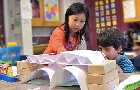 Children build with blocks and paper
