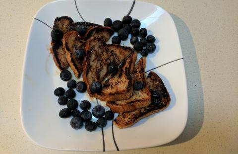 Plate with french toast and fresh blueberries.