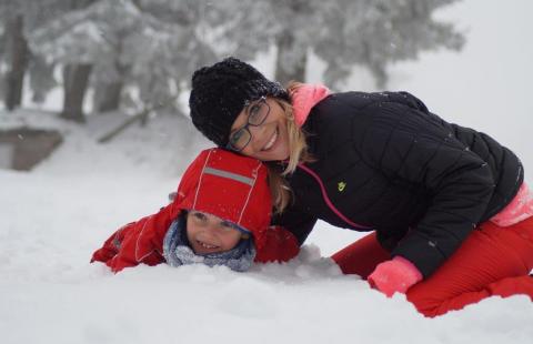 A woman and child in the snow.