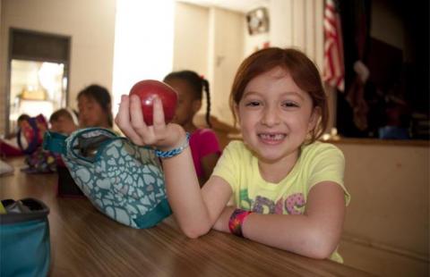 School Lunch girl holding apple