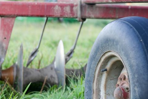 farm equipment in grass