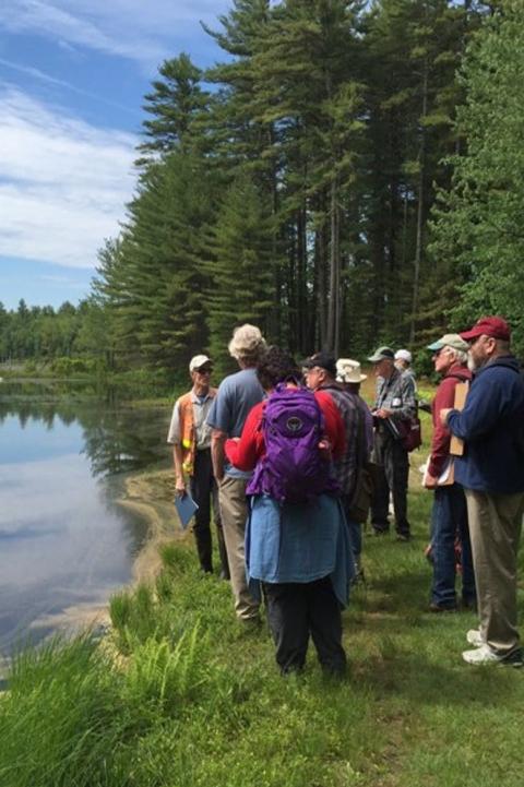 group outdoors at the edge of a lake