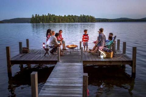 family at sunset on dock at NH lake