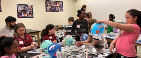 Kids work on a project with 4-H STEM