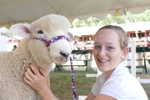 teenager showing a sheep at the fair