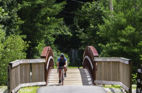 Man on a bike on a rail trail 