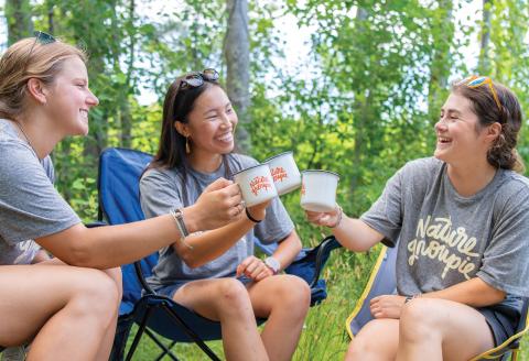 Three girls doing a cheers with Nature Groupie cups