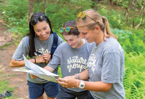 Three young girls looking at a map