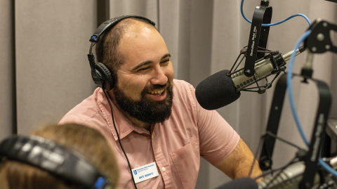 Nate speaking into a podcast setup